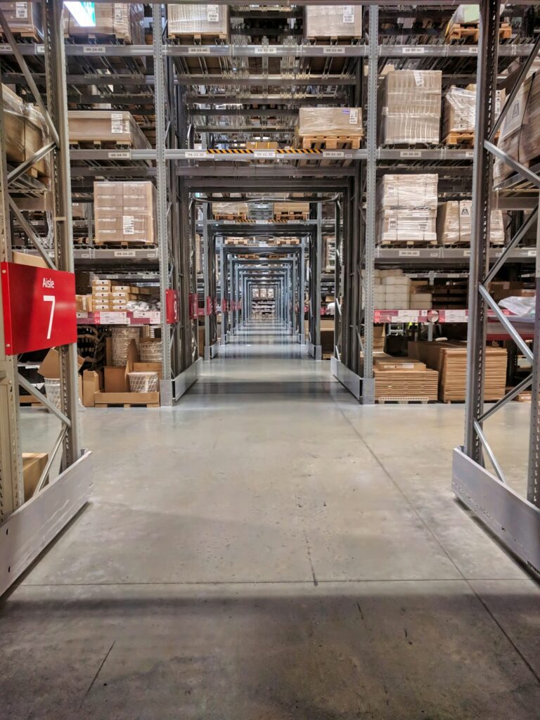 Shelved furniture and labeled boxes inside a clean, climate-controlled storage unit.